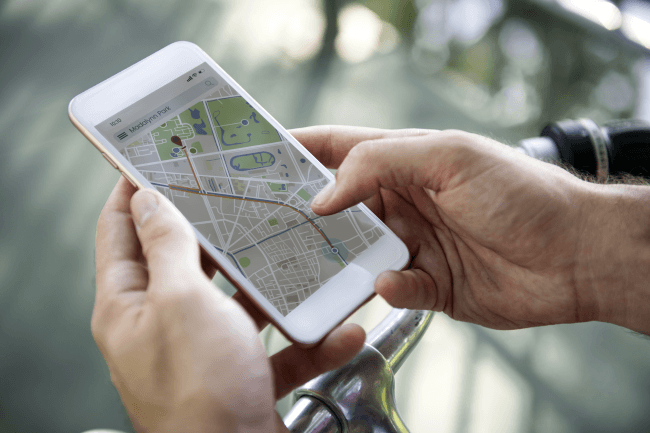Mand kontrollerer GPS på smartphone